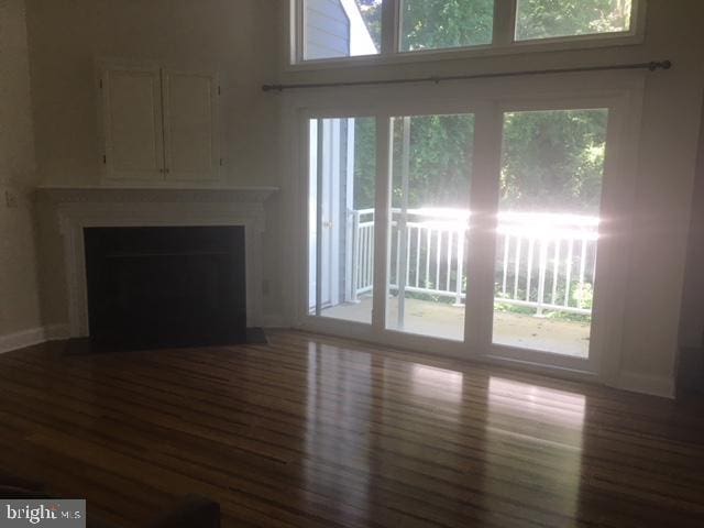 unfurnished living room featuring hardwood / wood-style flooring