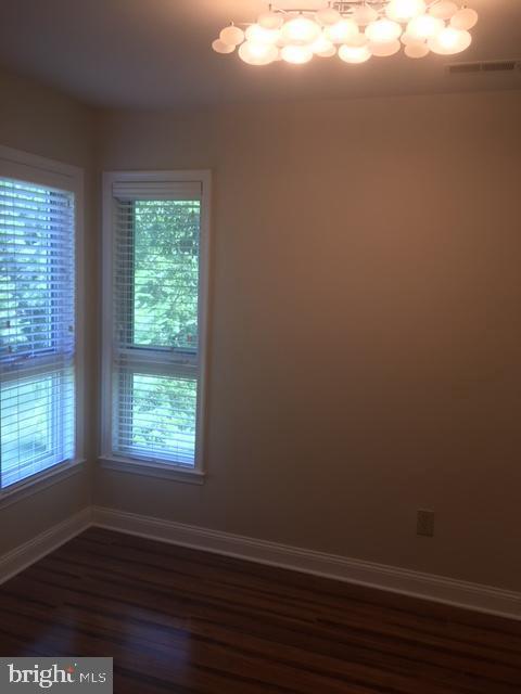 empty room with dark hardwood / wood-style flooring