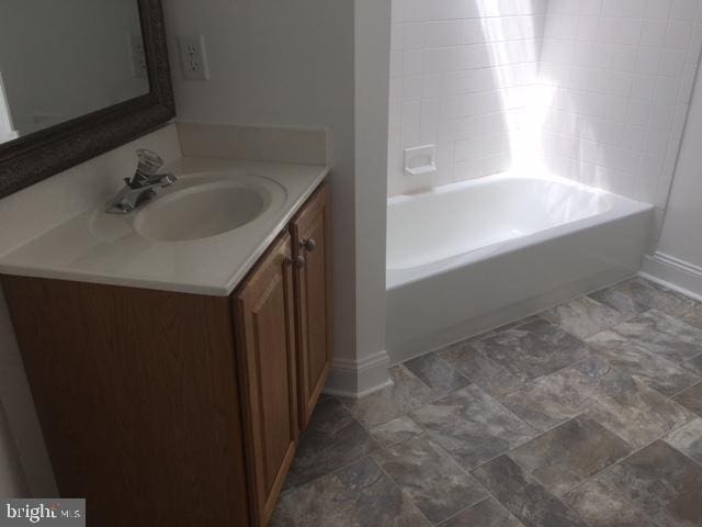 bathroom featuring bathing tub / shower combination and vanity