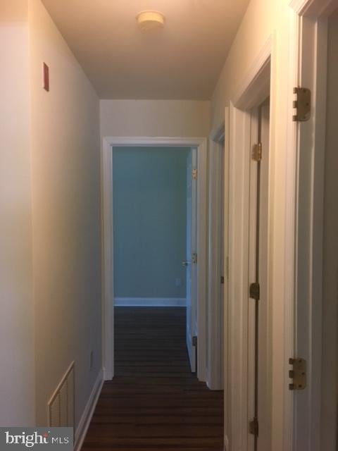 corridor featuring dark hardwood / wood-style floors