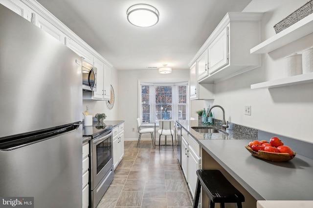 kitchen featuring white cabinets, appliances with stainless steel finishes, and sink