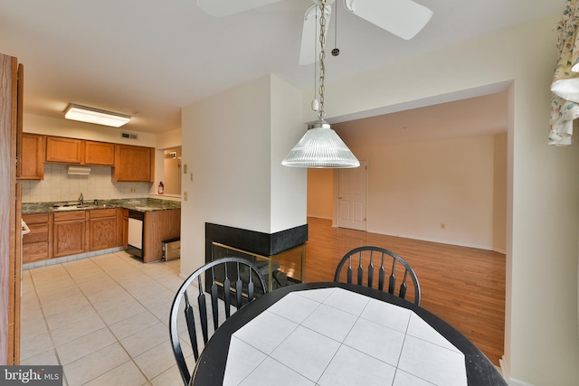 tiled dining area featuring sink