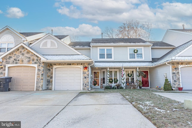 view of front property featuring a porch and a garage