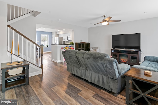 living room with wood-type flooring and ceiling fan