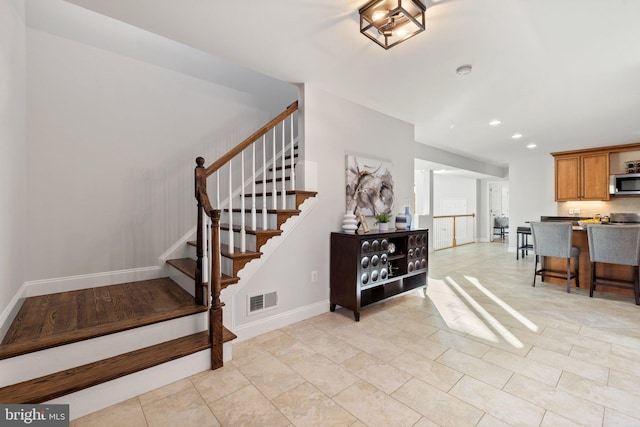 stairs featuring tile patterned flooring