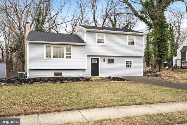 view of front of property with a front lawn and cooling unit