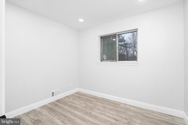 empty room with light hardwood / wood-style floors