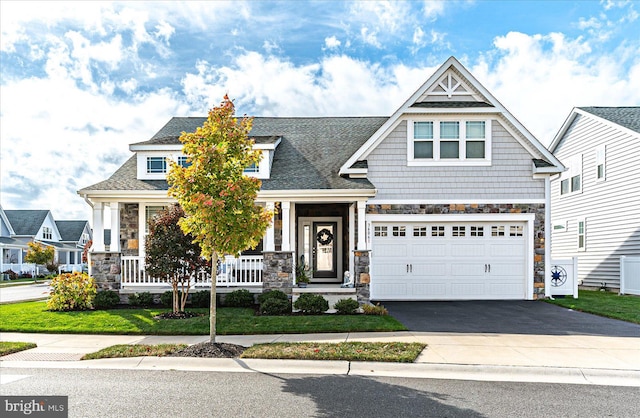 craftsman-style house with a porch and a garage