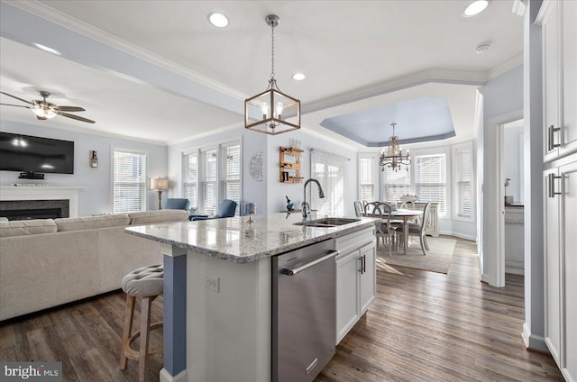 kitchen with stainless steel dishwasher, dark hardwood / wood-style floors, white cabinetry, and sink