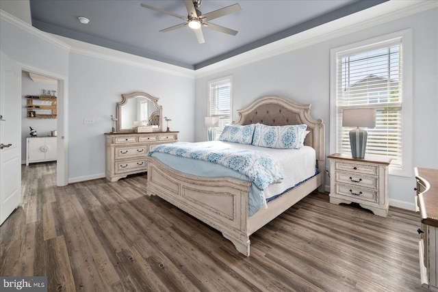 bedroom with ceiling fan, dark hardwood / wood-style floors, and ornamental molding