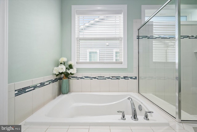 bathroom featuring separate shower and tub and a healthy amount of sunlight