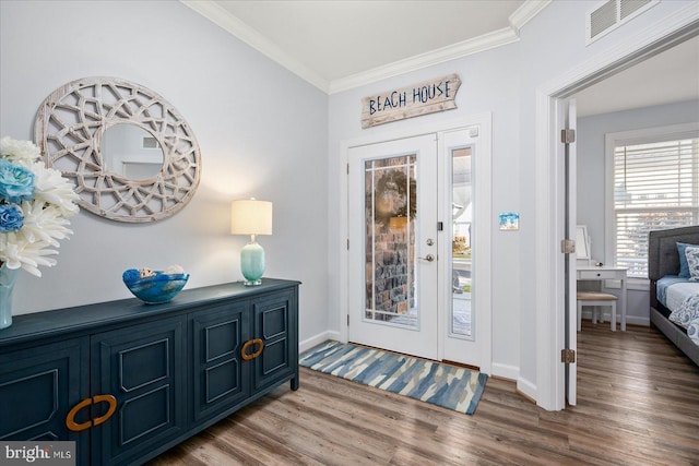 foyer with wood-type flooring and ornamental molding