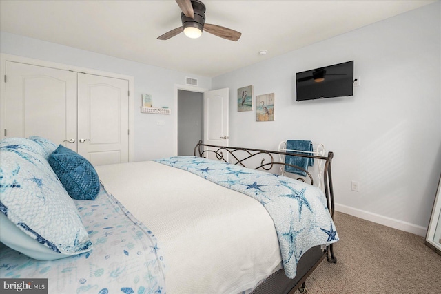 carpeted bedroom with ceiling fan and a closet