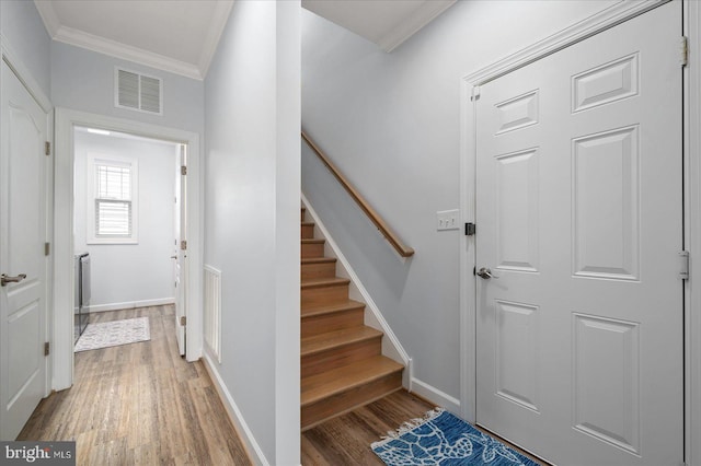 entryway featuring crown molding and wood-type flooring