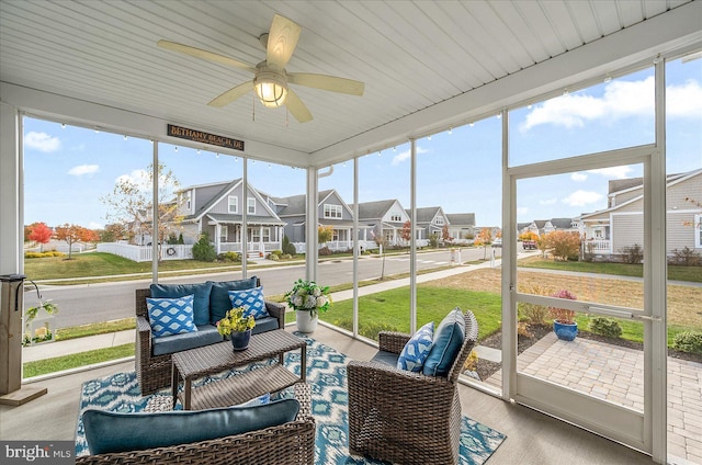 sunroom / solarium featuring plenty of natural light and ceiling fan