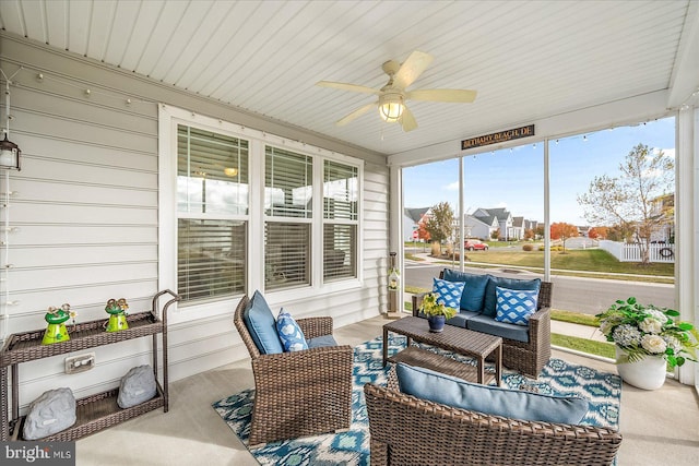 sunroom featuring ceiling fan