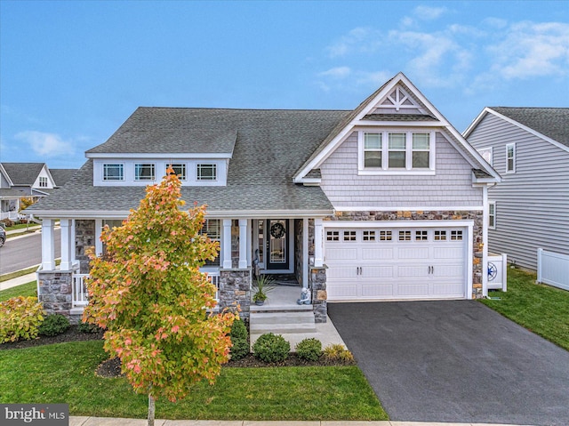 craftsman-style house featuring ac unit, a front lawn, and a garage