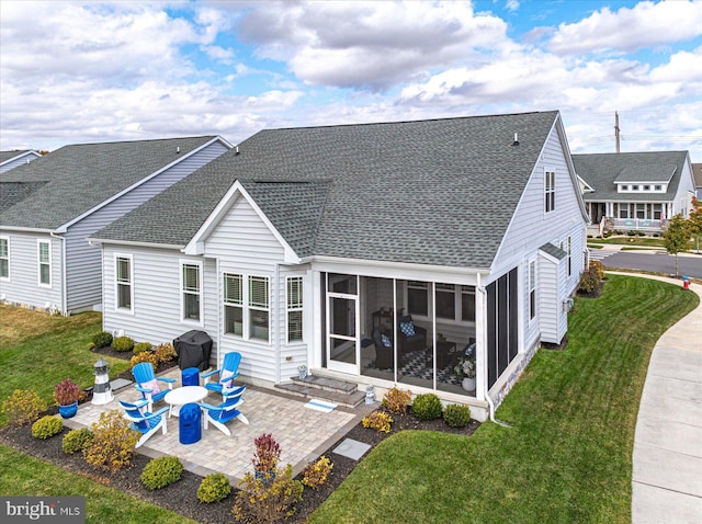 back of house with a sunroom, a patio area, and a yard