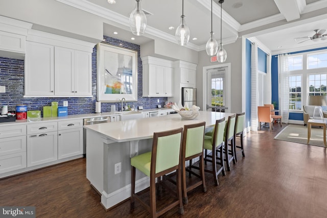 kitchen with white cabinets, a center island, and a healthy amount of sunlight