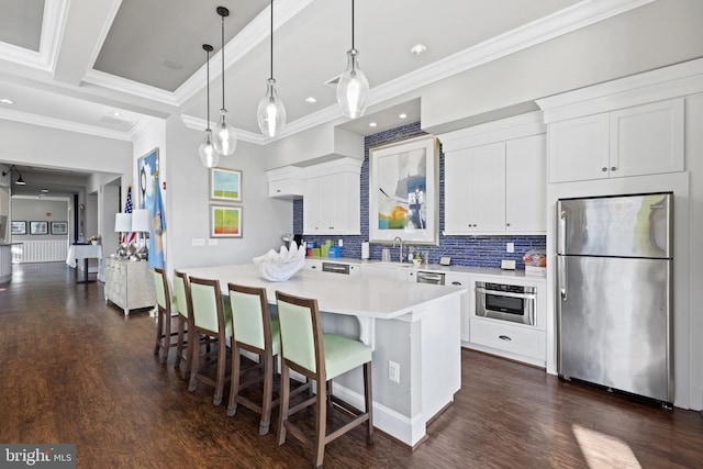 kitchen with white cabinets, a kitchen island, and stainless steel appliances