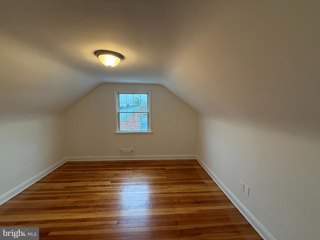 bonus room with hardwood / wood-style floors and lofted ceiling