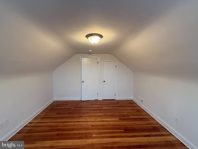 bonus room with lofted ceiling and wood-type flooring