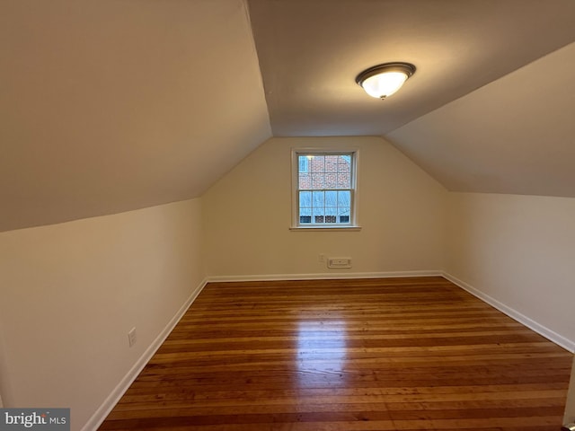 bonus room with lofted ceiling and dark hardwood / wood-style floors