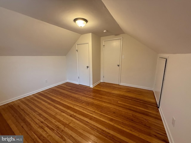 bonus room featuring hardwood / wood-style floors and vaulted ceiling