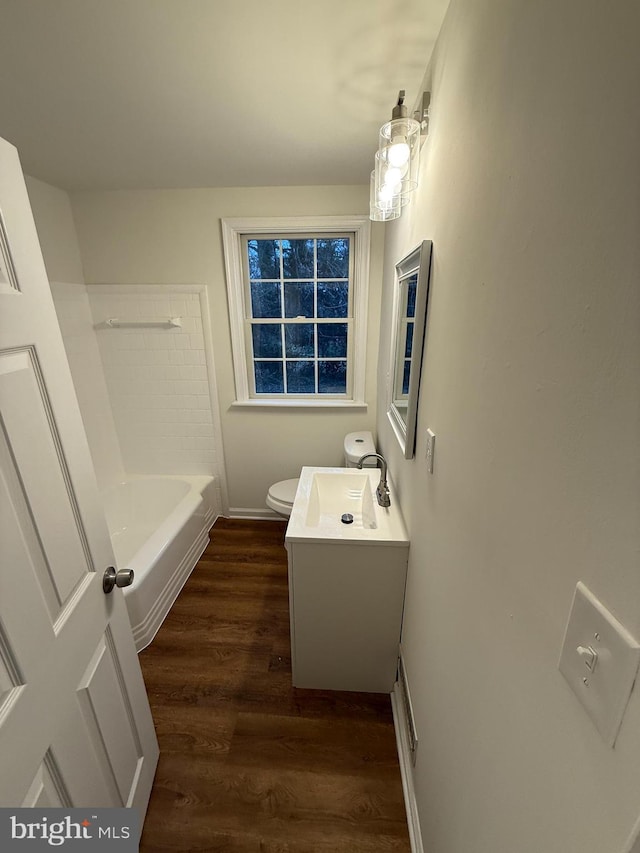 bathroom with toilet, vanity, and hardwood / wood-style flooring