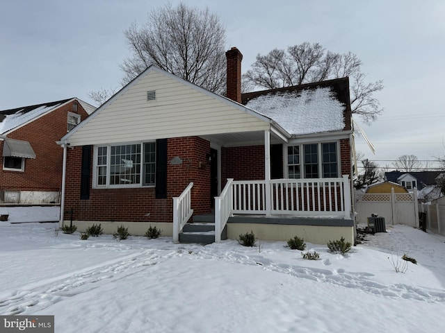 view of front facade with a porch and central AC