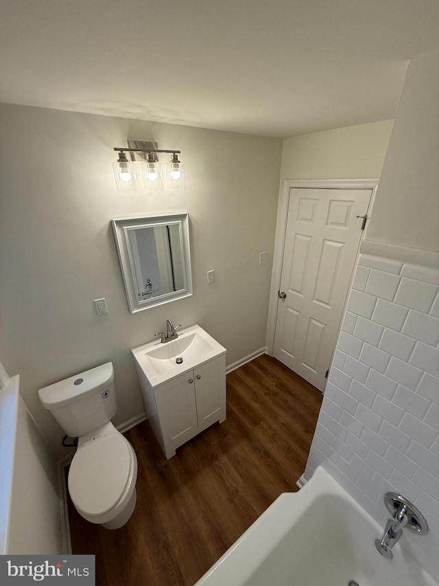 bathroom with vanity, toilet, and wood-type flooring