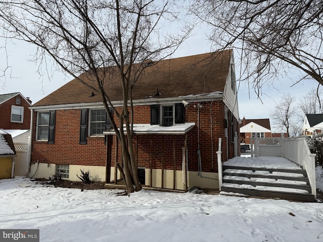 view of snow covered rear of property