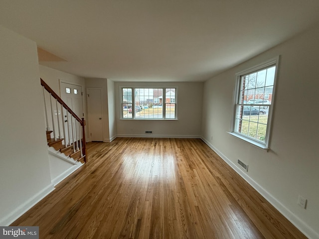 unfurnished living room featuring light hardwood / wood-style floors and a wealth of natural light