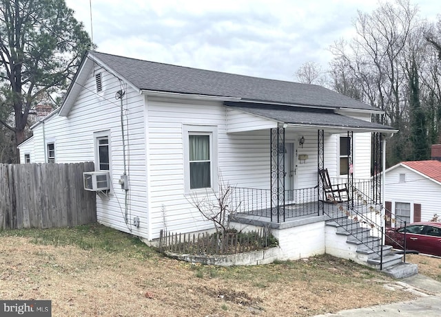 view of front of house featuring cooling unit and covered porch