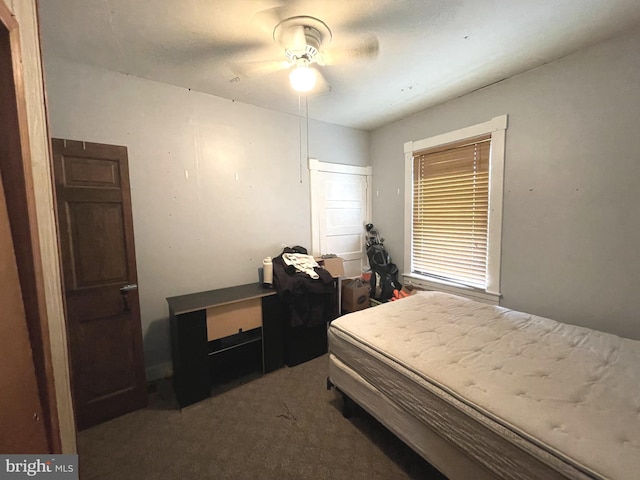 bedroom with ceiling fan and dark colored carpet