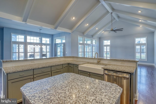 kitchen featuring sink, a kitchen island, vaulted ceiling with beams, and stainless steel dishwasher