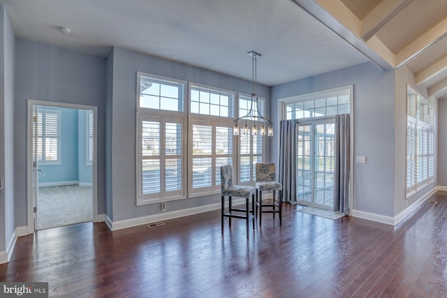 dining room with a chandelier, dark hardwood / wood-style floors, and plenty of natural light