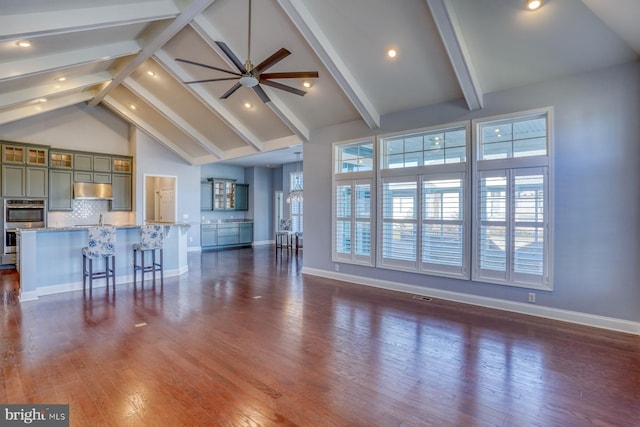 living room with dark hardwood / wood-style floors, beamed ceiling, high vaulted ceiling, and ceiling fan