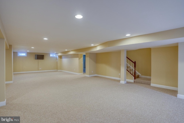 basement featuring light colored carpet