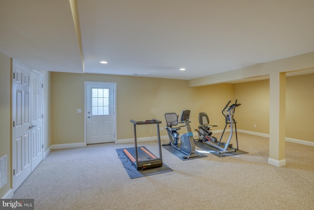 workout room featuring light colored carpet