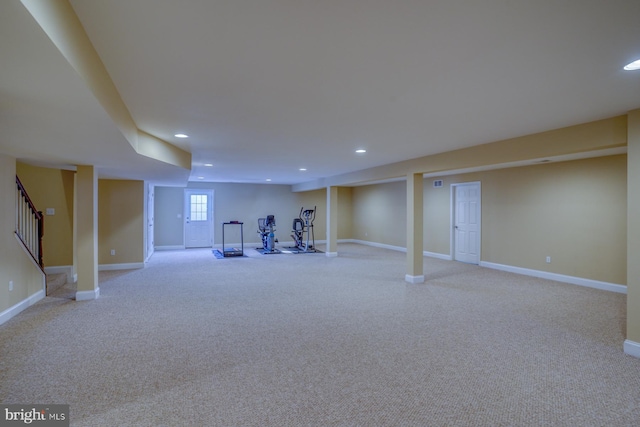 basement featuring light carpet