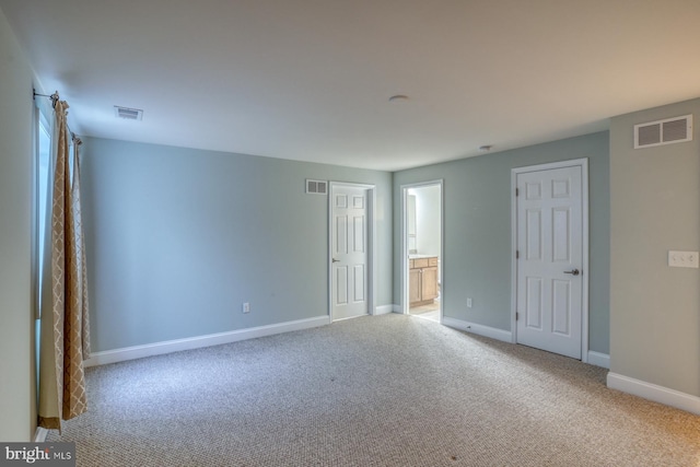 empty room featuring light colored carpet