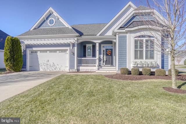 view of front facade with a front yard, a porch, and a garage