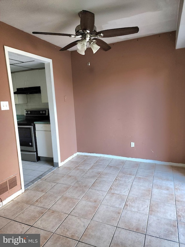 tiled empty room featuring ceiling fan