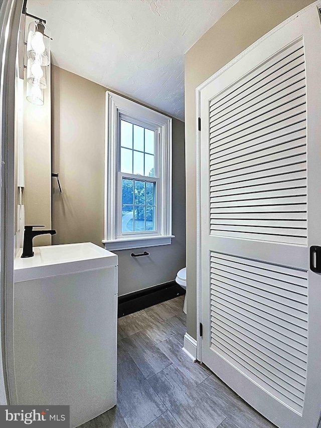 bathroom featuring sink, a textured ceiling, and toilet