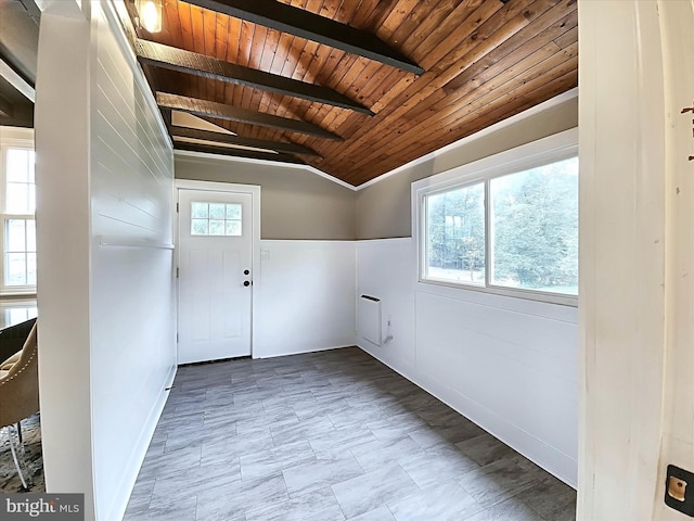 interior space with vaulted ceiling with beams and wood ceiling