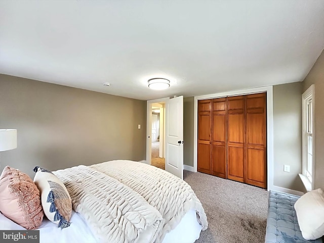 carpeted bedroom featuring a closet