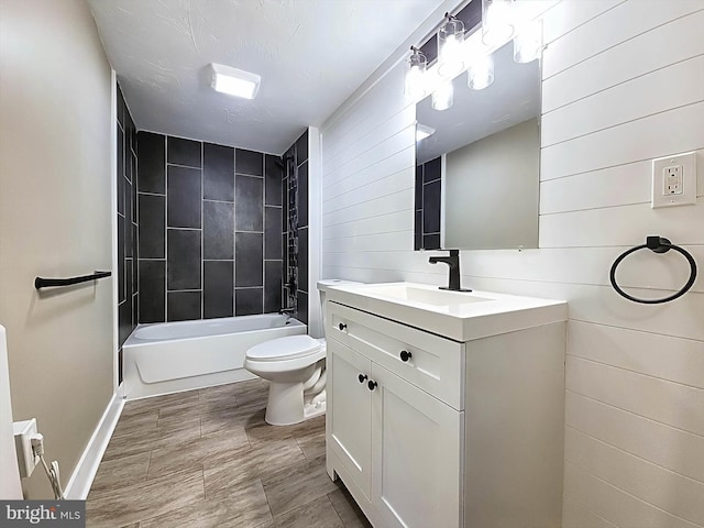 full bathroom with vanity, toilet, and tiled shower / bath