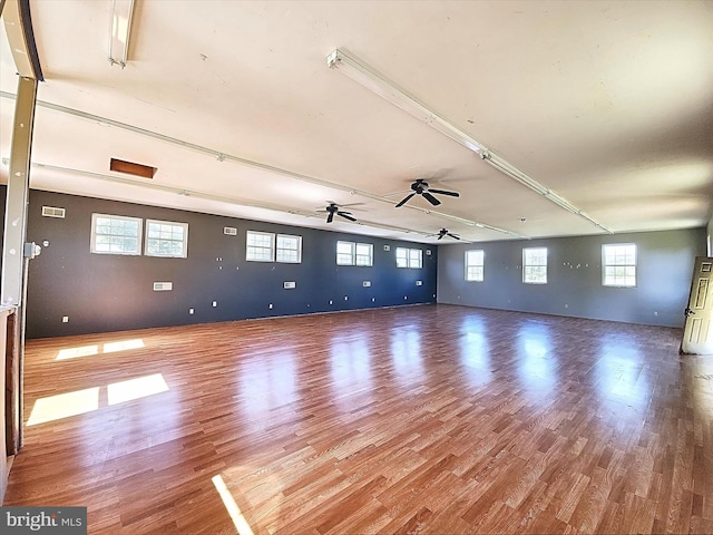 unfurnished room with wood-type flooring and a wealth of natural light