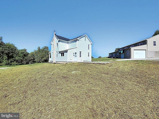 exterior space with a garage and a yard